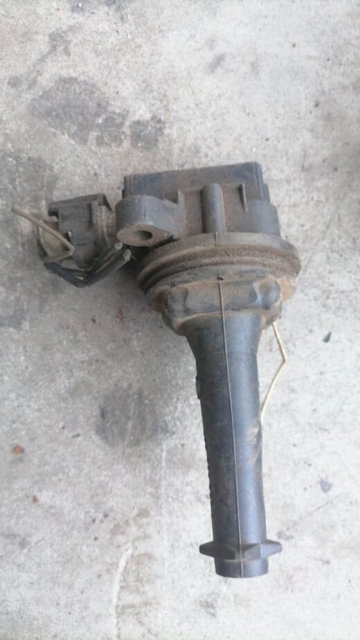 Close-up of a black coil spring for a Volvo, viewed from a slight angle showing its tight coils.Close-up of a