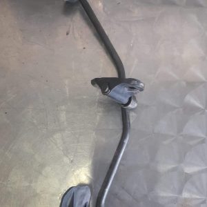 Close-up of a car accelerator pedal positioned upright against a white background.Close-up of a car accelerato