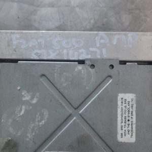 Front view of a Fiat 500 car amplifier with wiring harnesses and connectors visible, on a white background.Fro