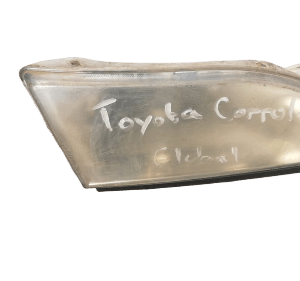 Right front headlight for Toyota Corolla viewed from the side, used condition, with clear lens and mounting po