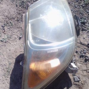 Right front headlight assembly for Toyota Hilux, used condition, shown angled facing left.Right front headligh