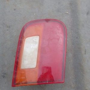 Left inner taillight for Honda Ballade, angled view showing red and amber lens, used condition.Left inner tail