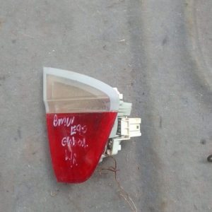 Left inner taillight for BMW E90, angled front view, used condition, showing lens and mounting points.Left inn